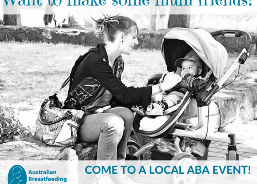 Woman sitting down outside and looking fondly at a baby that is sitting in a stroller. 